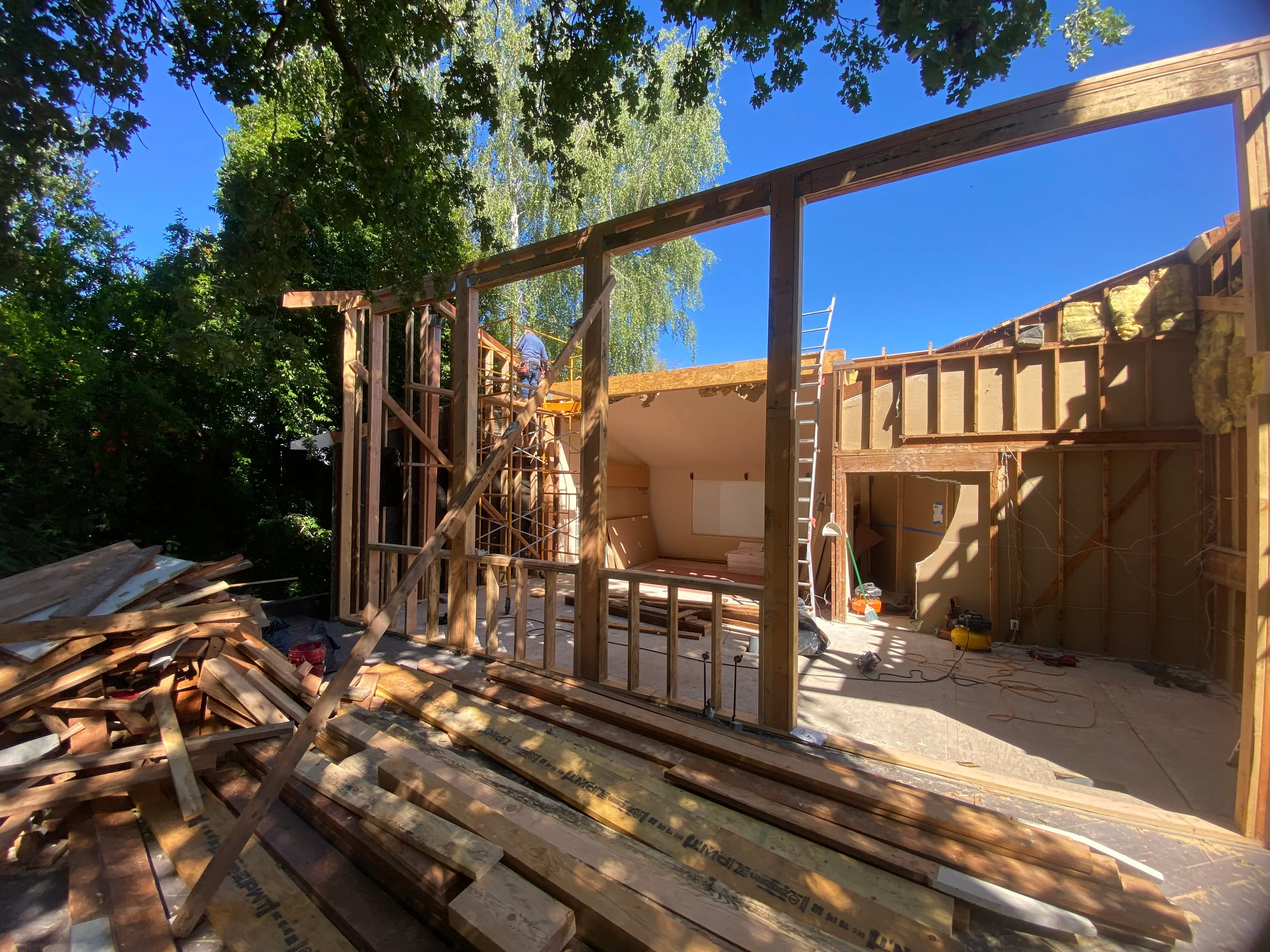 Residential addition framing with steel beams and wood studs under construction